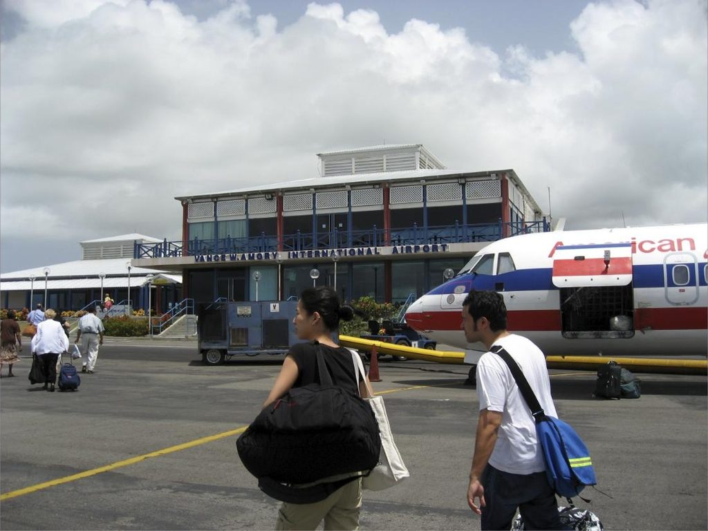 Terminal facade of Vance W. Amory International Airport on Nevis, with passengers on the tarmac